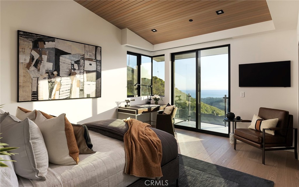 12530 Stagecoach Road Malibu, CA 90265 - Photo 21 of 45 a bedroom with furniture and a flat screen tv