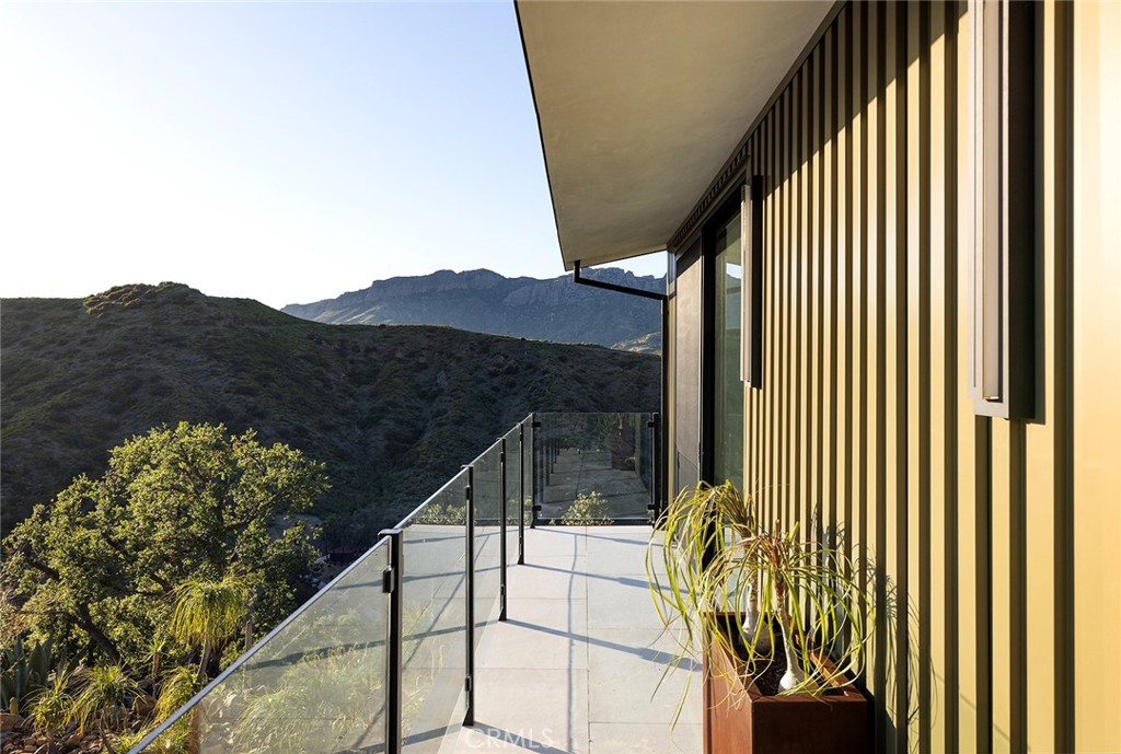 12530 Stagecoach Road Malibu, CA 90265 - Photo 23 of 45 a view of balcony with floor to ceiling window and wooden fence