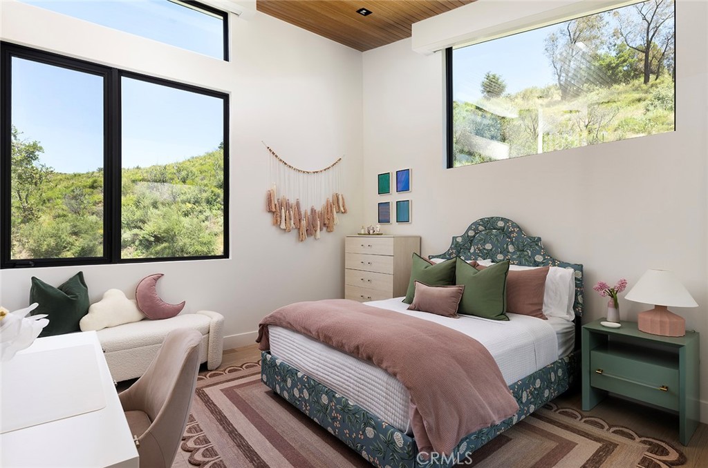 12530 Stagecoach Road Malibu, CA 90265 - Photo 26 of 45 a bedroom with a bed and wooden floor