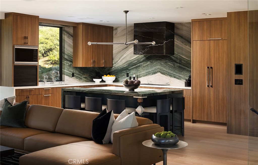 12530 Stagecoach Road Malibu, CA 90265 - Photo 8 of 45 a living room with furniture a fireplace and a chandelier