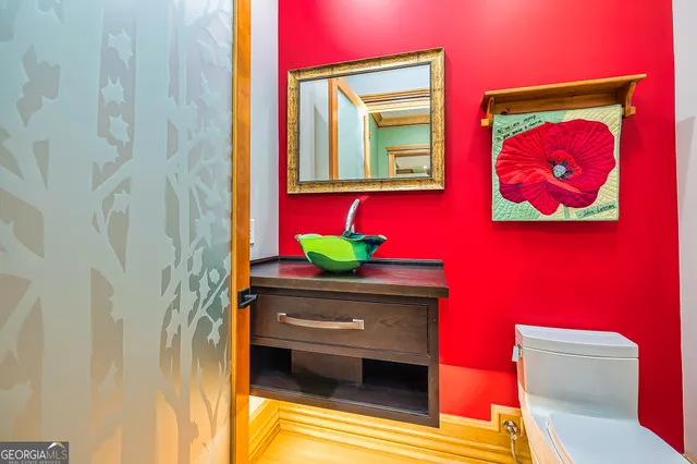 a bathroom with a toilet sink and mirror