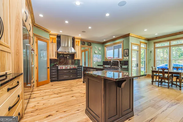 a kitchen with stainless steel appliances granite countertop sink stove and refrigerator