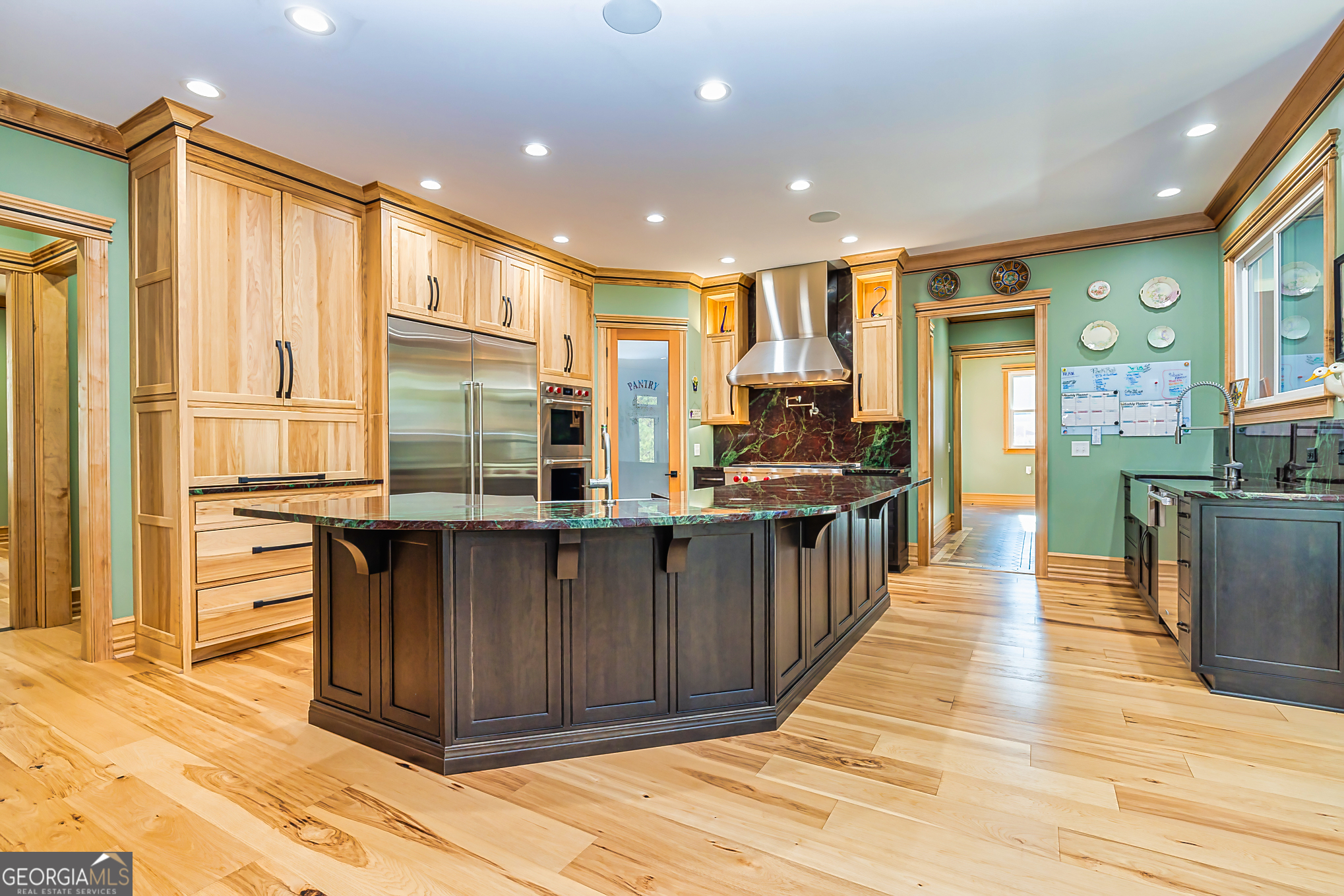 242 Kirkley Road Tyrone, GA 30290 - Photo 13 of 50 a kitchen with stainless steel appliances granite countertop a refrigerator a sink dishwasher and wooden cabinets with wooden floor