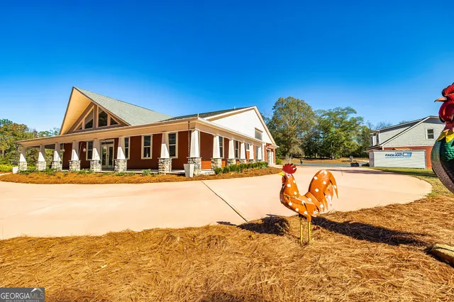 a view of a house with pool and ocean view
