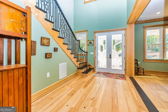 a view of an entryway with wooden floor and door