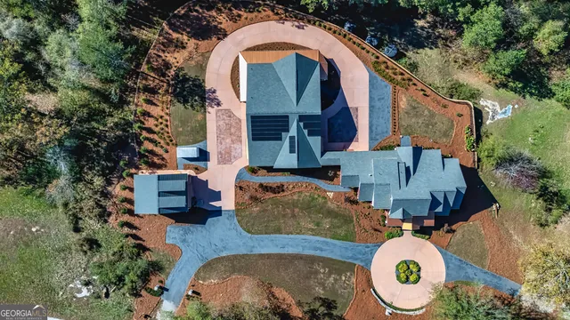an aerial view of a house with swimming pool and outdoor space