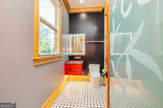 a bathroom with a sink a toilet and shower curtain