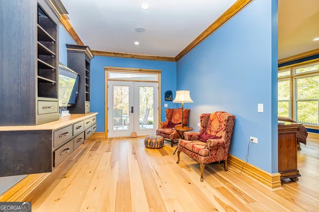 a large white room with a couch and wooden floor