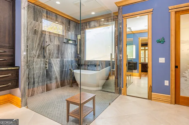 a living room with a large window and furniture