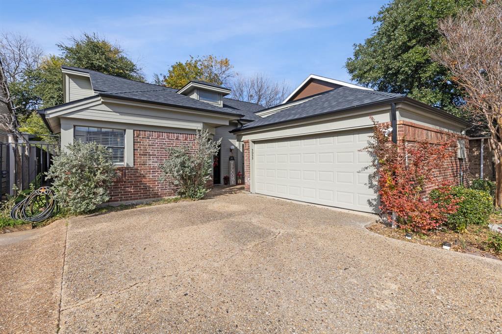 a view of a house with a yard and garage
