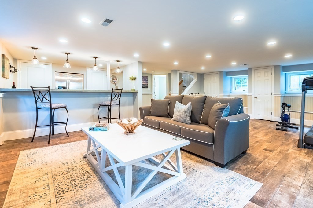 18 Damon Road Scituate, MA 02066 - Photo 11 of 25 a living room with furniture and a dining table with wooden floor