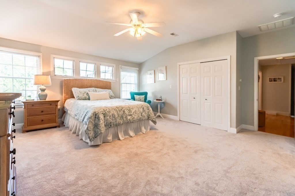 18 Damon Road Scituate, MA 02066 - Photo 15 of 25 a bedroom with a bed and a chandelier