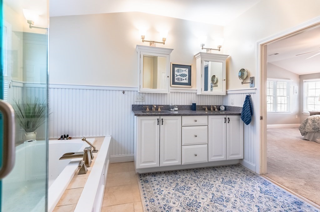 18 Damon Road Scituate, MA 02066 - Photo 18 of 25 a spacious bathroom with a granite countertop sink and a mirror