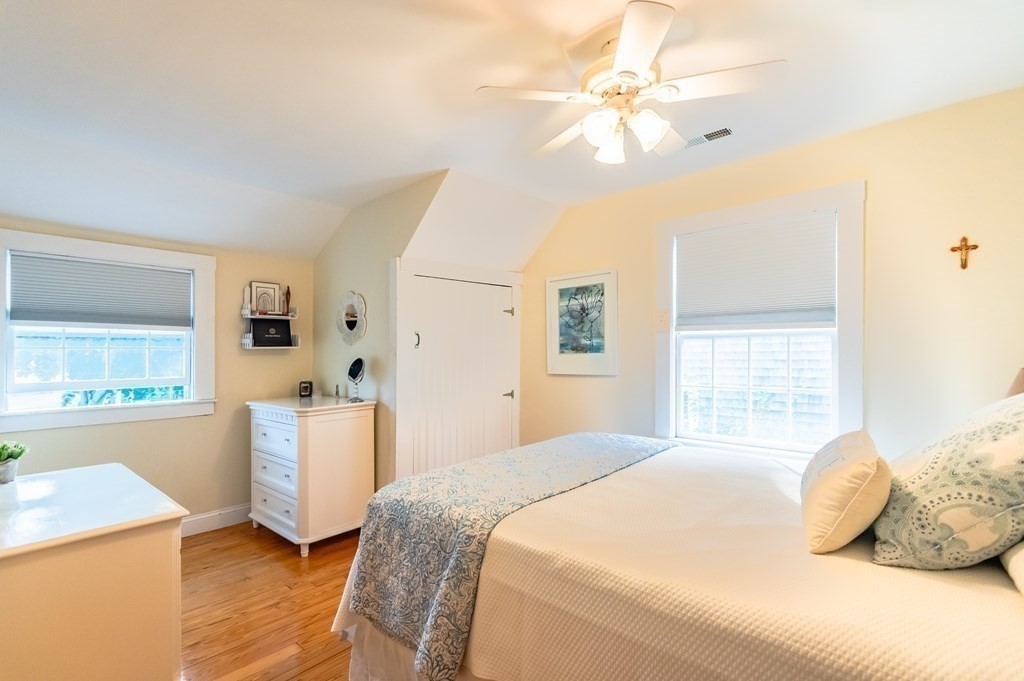 18 Damon Road Scituate, MA 02066 - Photo 19 of 25 a bedroom with a bed and a chandelier