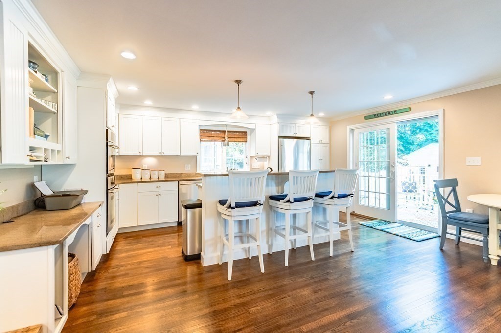 18 Damon Road Scituate, MA 02066 - Photo 3 of 25 a kitchen with stainless steel appliances wooden floor and a refrigerator