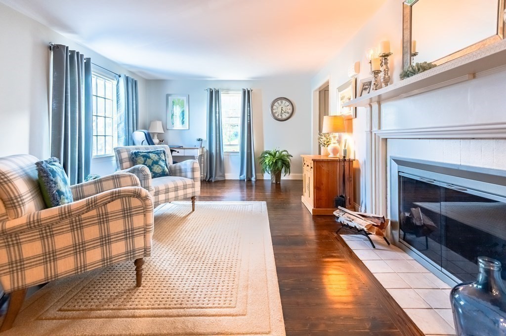 18 Damon Road Scituate, MA 02066 - Photo 8 of 25 a living room with patio furniture and a fireplace