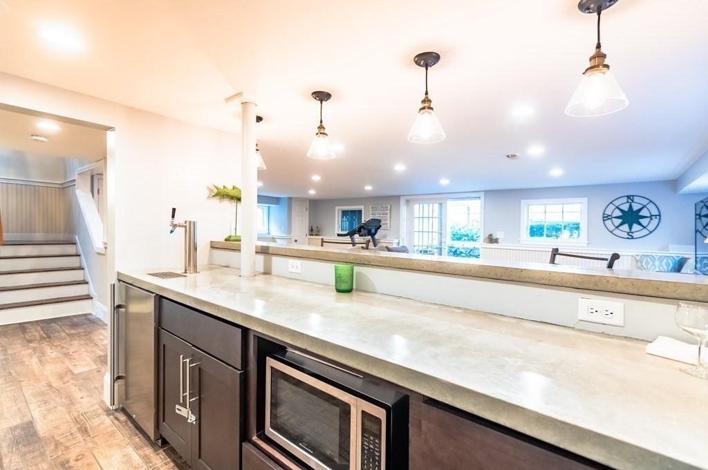 18 Damon Road Scituate, MA 02066 - Photo 10 of 25 a large kitchen with kitchen island a large counter space a sink and appliances