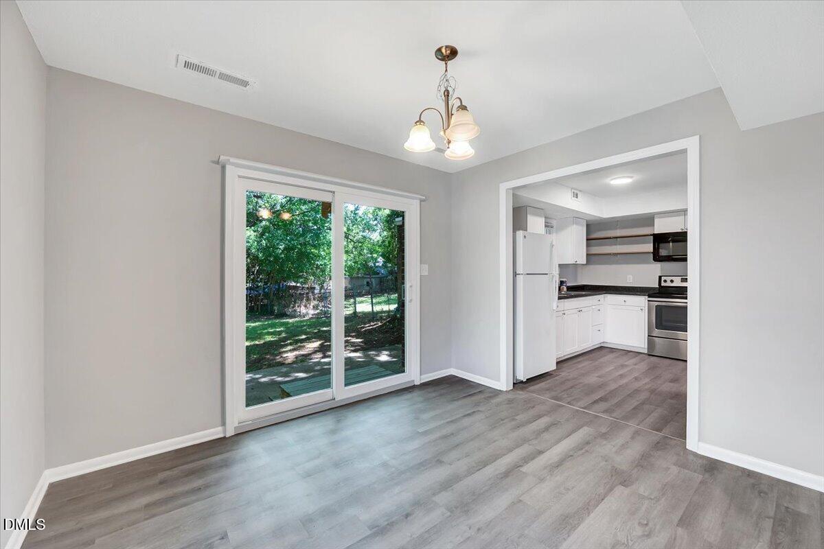3408 Atlantic Avenue Raleigh, NC 27604 - Photo 34 of 48 a view of a kitchen with wooden floor a ceiling fan and windows