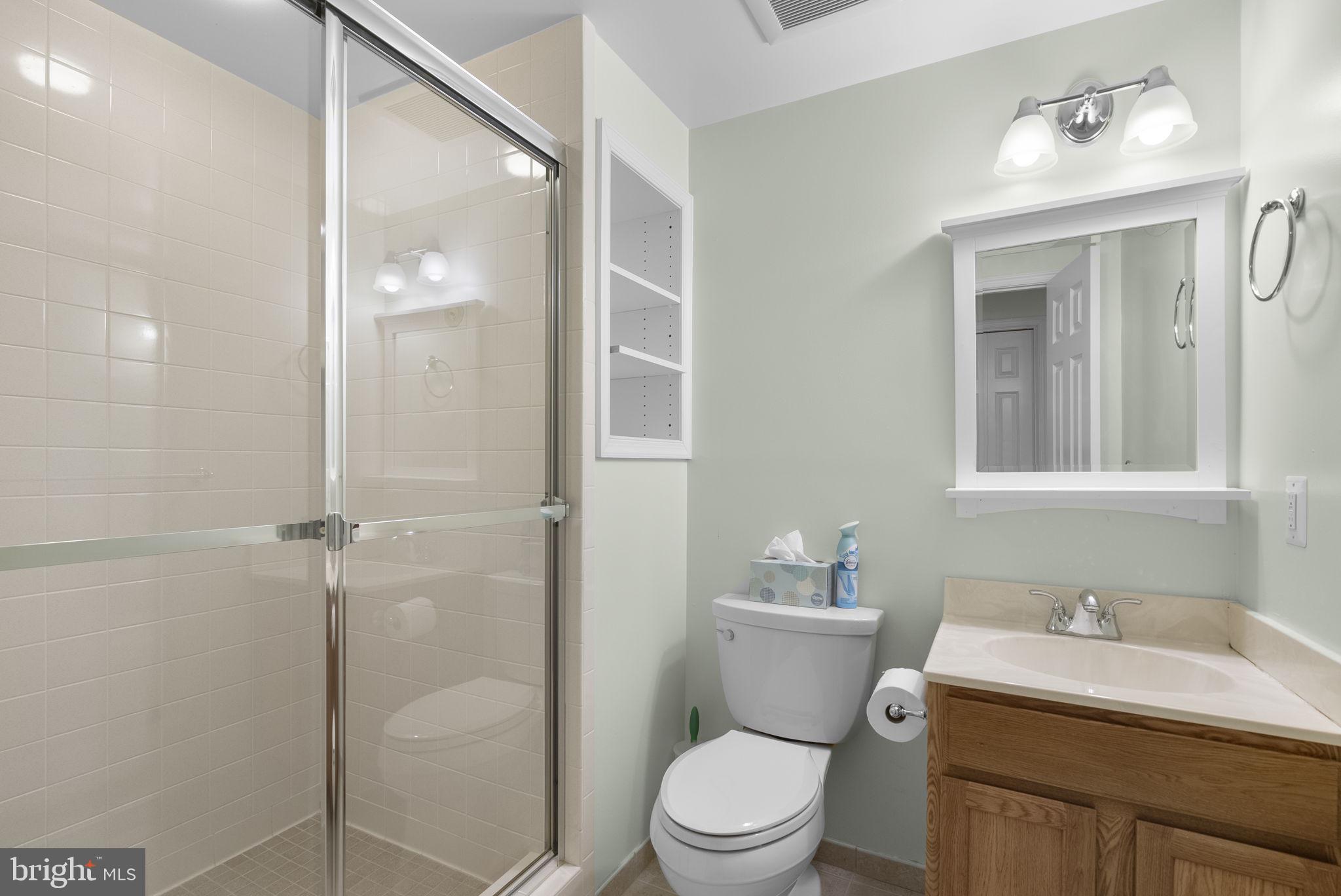 15220 Redgate Drive Silver Spring, MD 20905 - Photo 48 of 65 a bathroom with a granite countertop sink toilet a mirror and shower