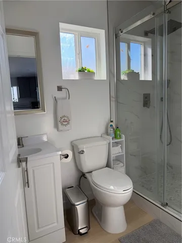 a white toilet sitting next to a bathroom sink