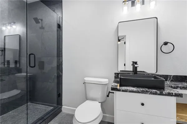 a bathroom with a toilet a sink and a shower