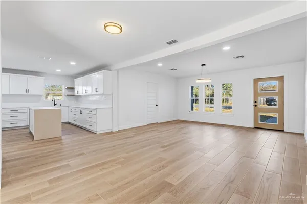 a view of a kitchen with stove and cabinets