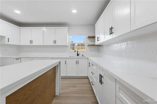a kitchen with cabinets and white appliances