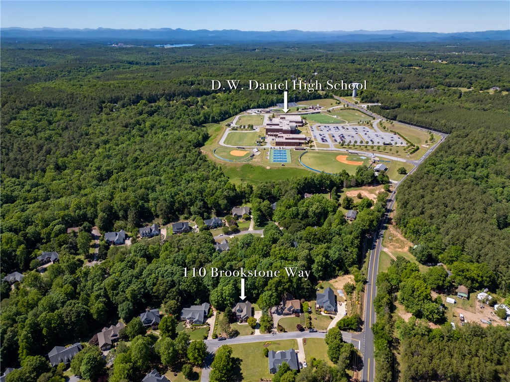 110 Brookstone Way Central, SC 29630 - Photo 43 of 46 An expansive aerial perspective captures a residential area nestled amidst lush green landscapes and rolling hills.