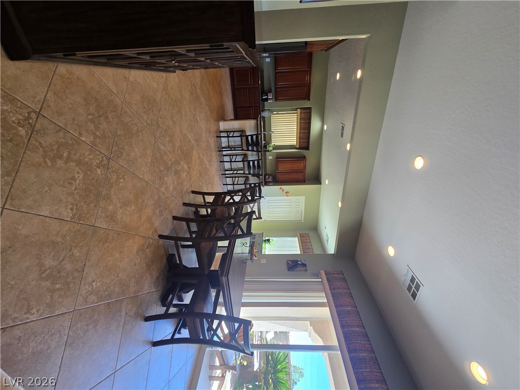 2567 Dirleton Place Henderson, NV 89044 - Photo 19 of 67 Recessed lighting illuminates this dining space with its rich tile flooring and outdoor views.