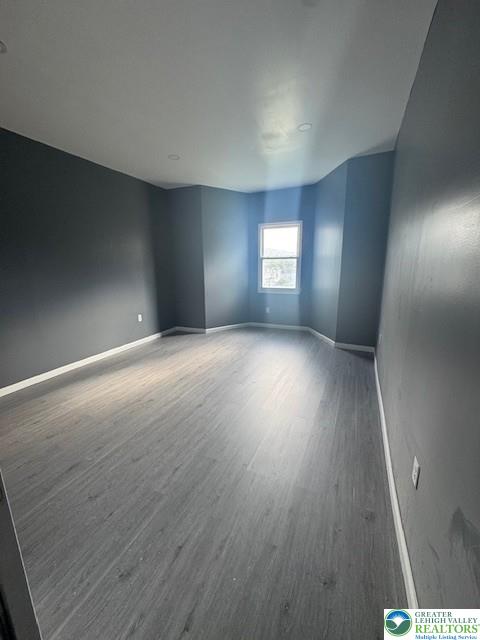 116 East Ridge Street, Unit 1 Coaldale, PA 18218 - Photo 3 of 7 an empty room with wooden floor and windows