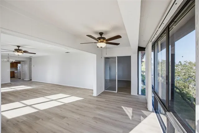 a view of an empty room and a ceiling fan cabinet