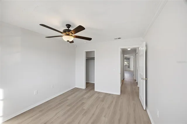 a view of an empty room with wooden floor