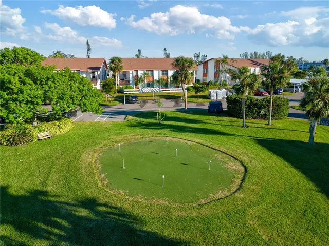 a view of a fountain in front of a house with a big yard