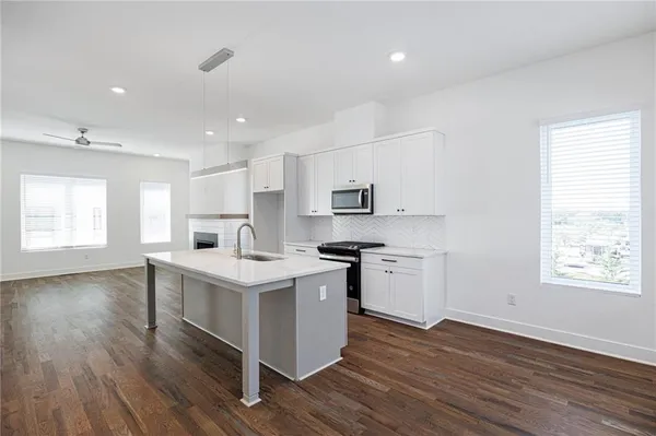 a kitchen that has a sink and a stove