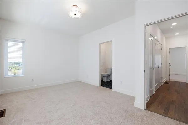 a bathroom with a bathtub shower sink mirror vanity and toilet