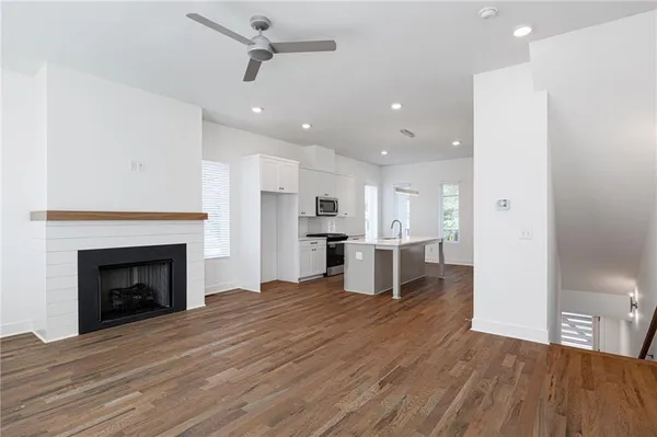 a view of empty room with wooden floor and fireplace