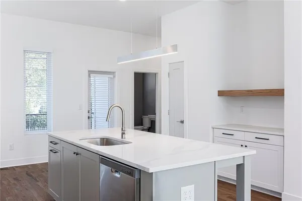 a kitchen with a stove a sink and a refrigerator