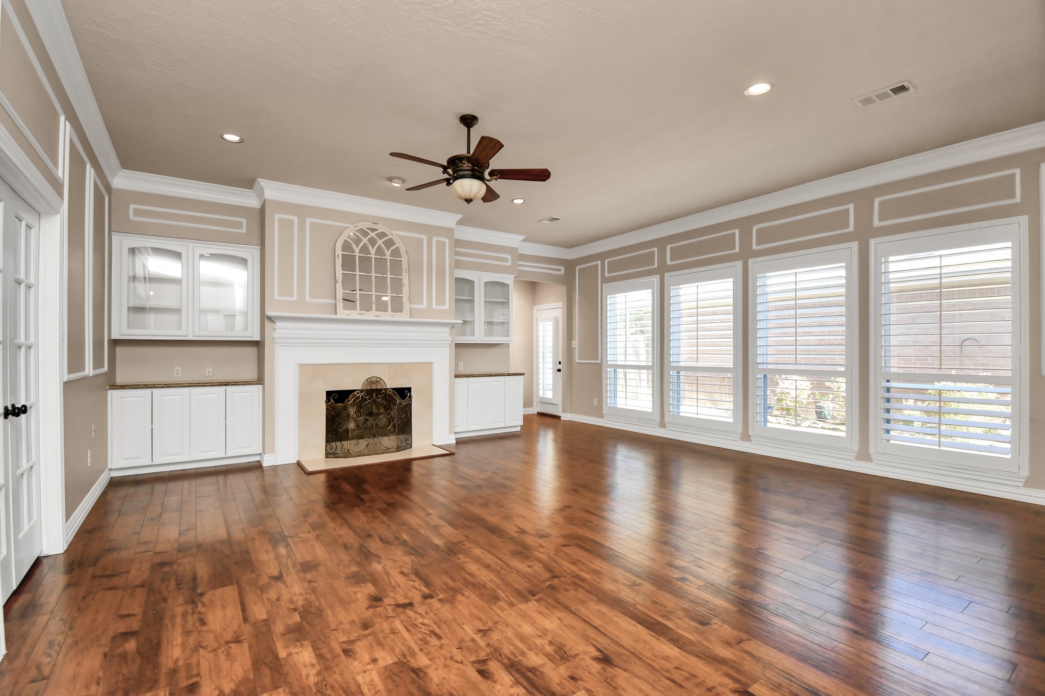 4411 Walham Court Houston, TX 77345 - Photo 12 of 46 a view of an empty room with wooden floor and a window