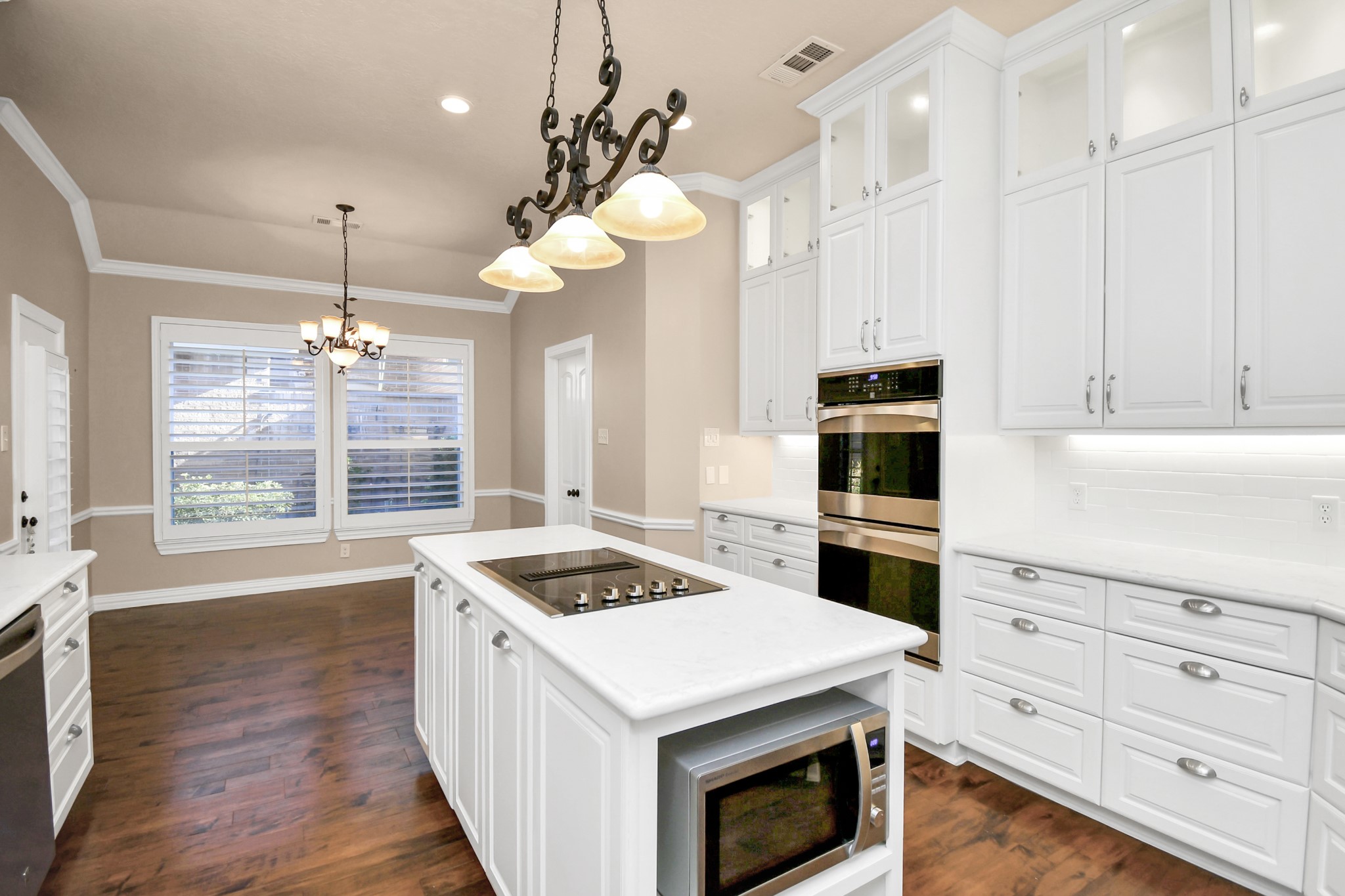 4411 Walham Court Houston, TX 77345 - Photo 15 of 46 a kitchen with a stove cabinets and wooden floor