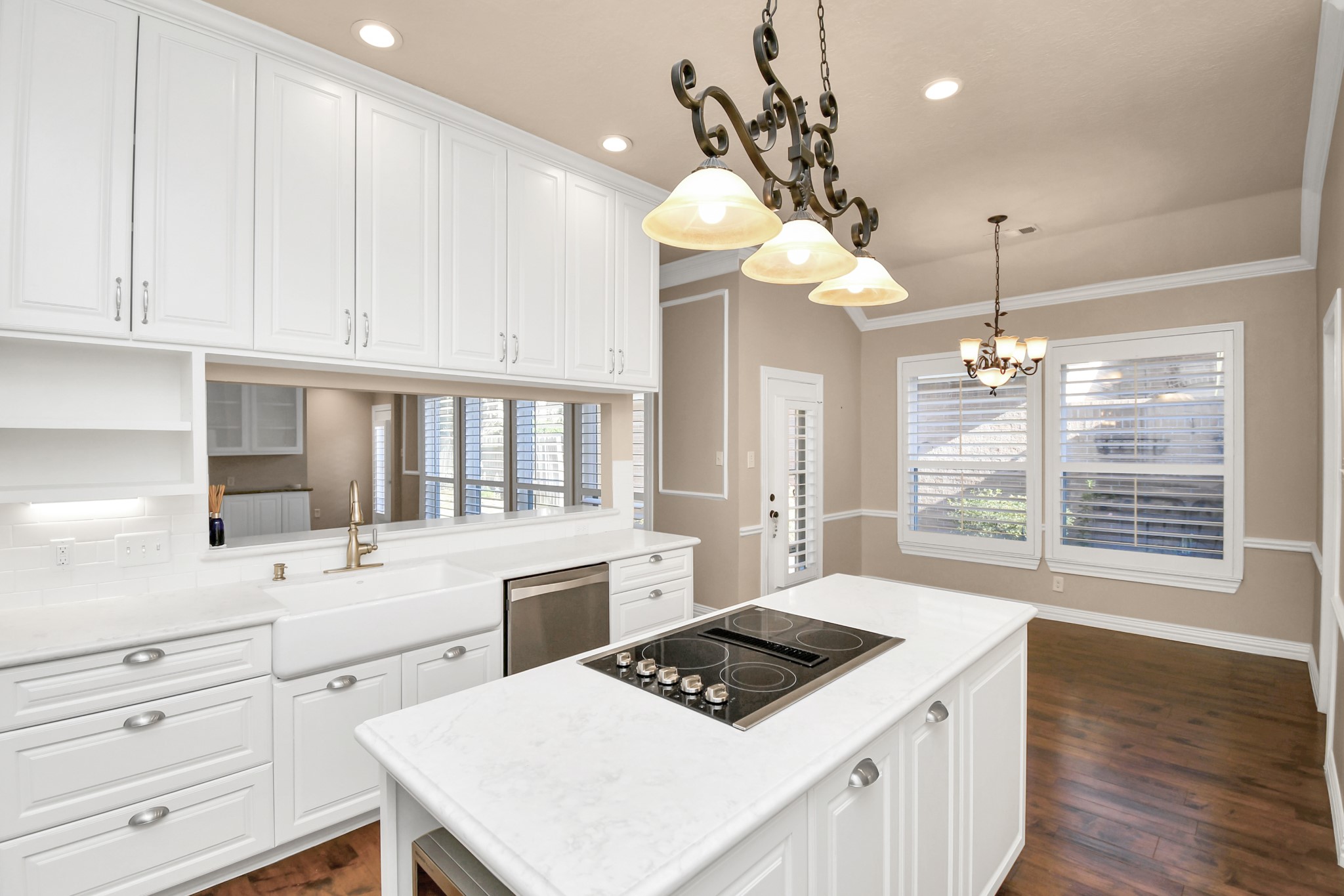 4411 Walham Court Houston, TX 77345 - Photo 17 of 46 a kitchen with a stove a sink a chandelier and wooden floor