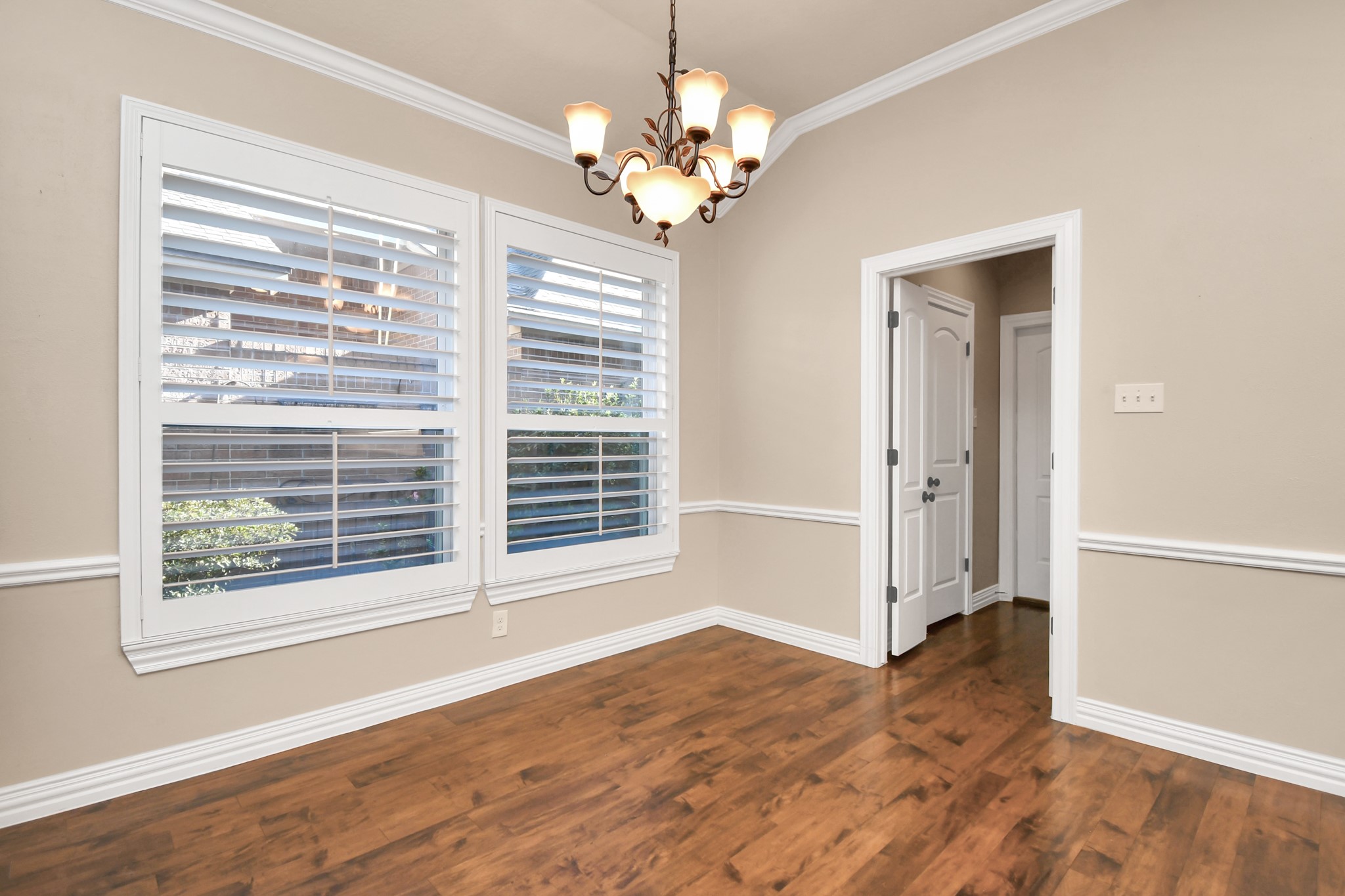 4411 Walham Court Houston, TX 77345 - Photo 19 of 46 a view of an empty room with wooden floor and a window