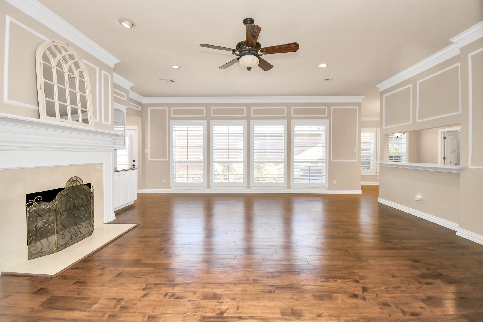 4411 Walham Court Houston, TX 77345 - Photo 23 of 46 a view of an empty room with wooden floor and a fireplace
