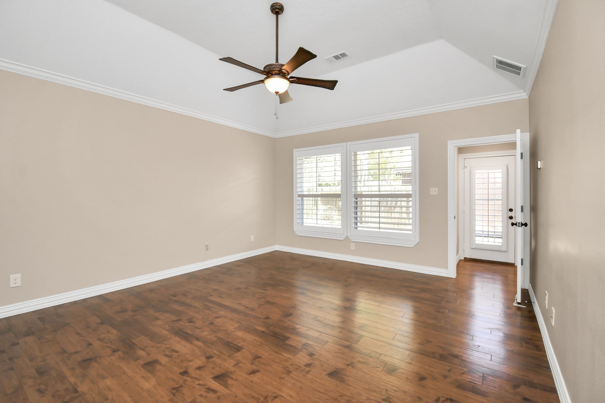 4411 Walham Court Houston, TX 77345 - Photo 27 of 46 a view of an empty room with a window and wooden floor