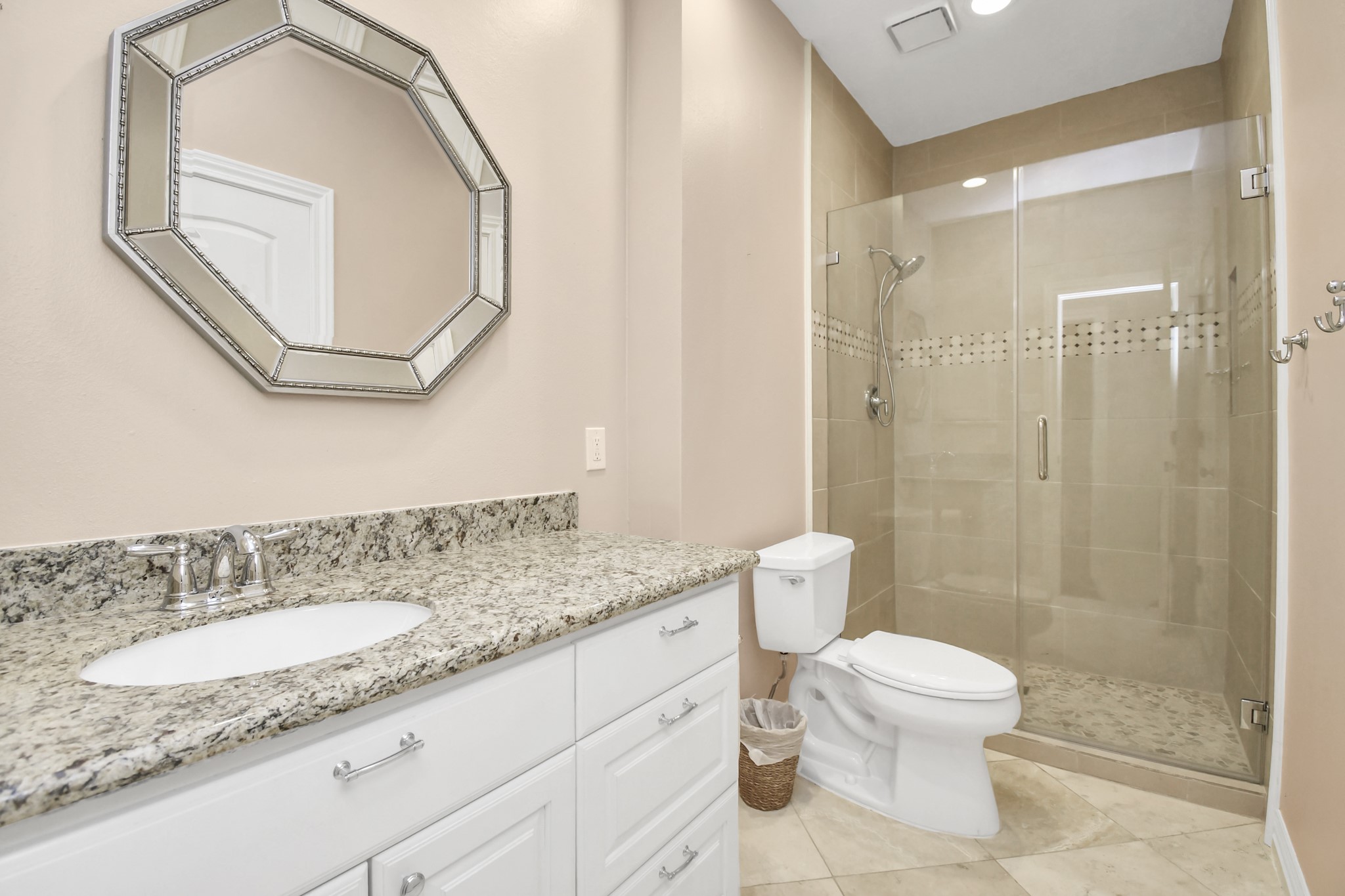 4411 Walham Court Houston, TX 77345 - Photo 39 of 46 a bathroom with a granite countertop sink a mirror and a toilet