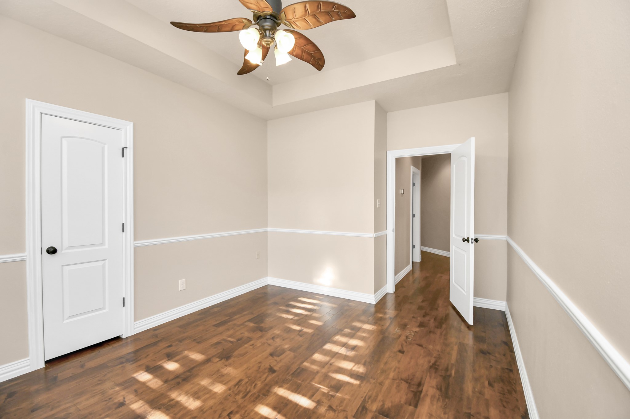 4411 Walham Court Houston, TX 77345 - Photo 41 of 46 a view of a hallway with wooden floor and chandelier fan