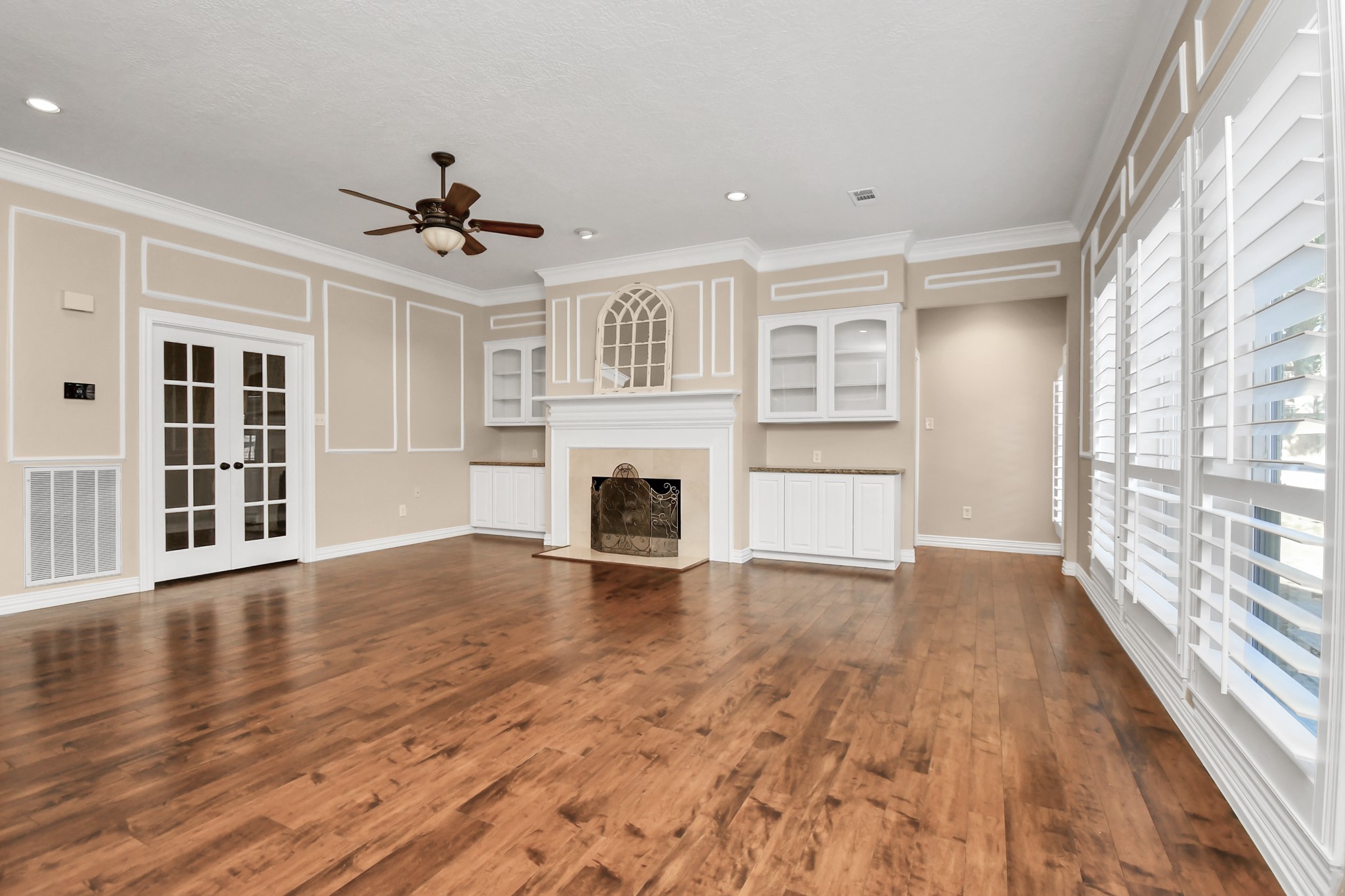 4411 Walham Court Houston, TX 77345 - Photo 9 of 46 a view of an empty room with wooden floor and a window