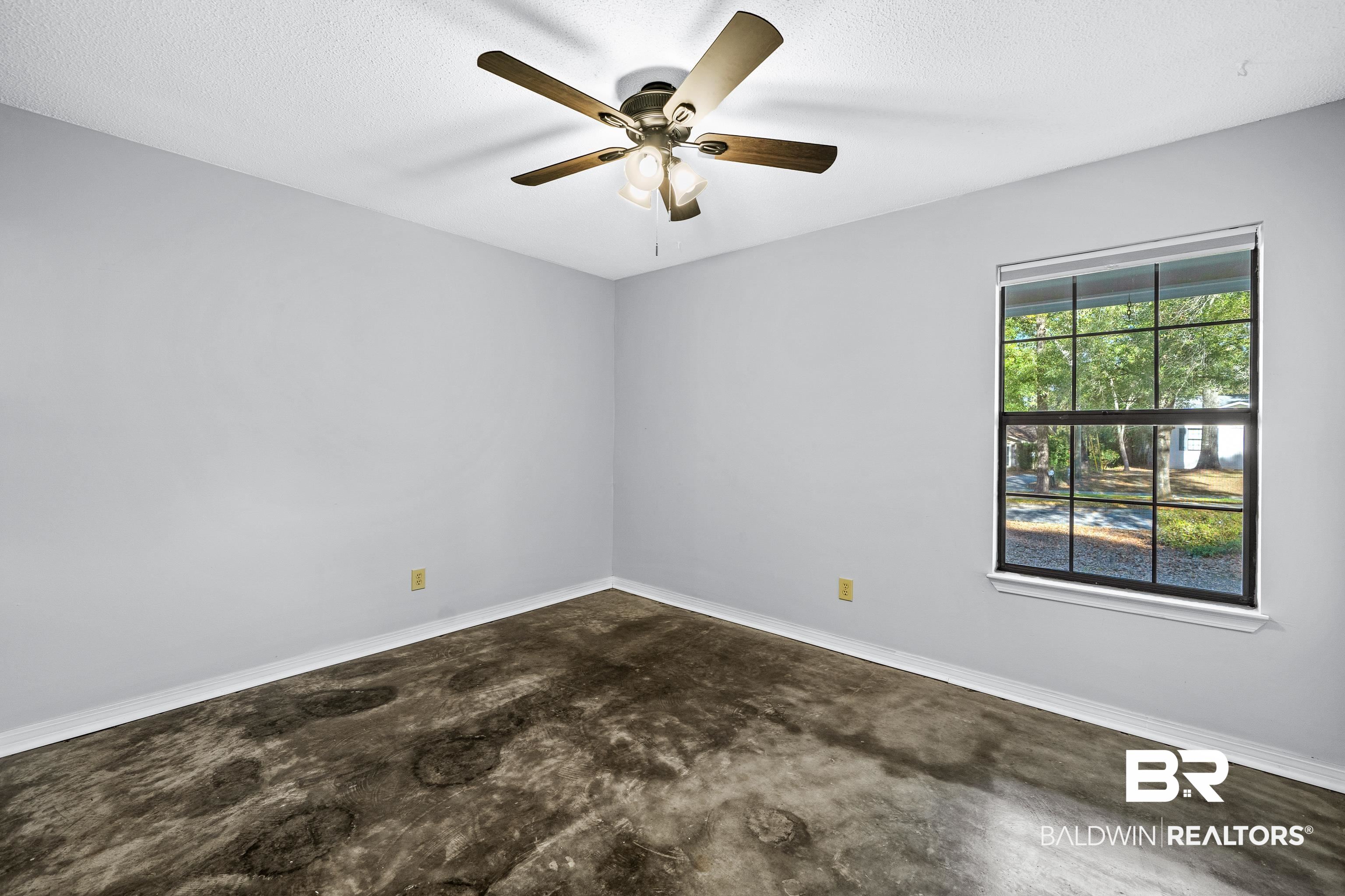 511 Ridgewood Drive Daphne, AL 36526 - Photo 23 of 59 Unfurnished room with a textured ceiling, ceiling fan, and a healthy amount of sunlight