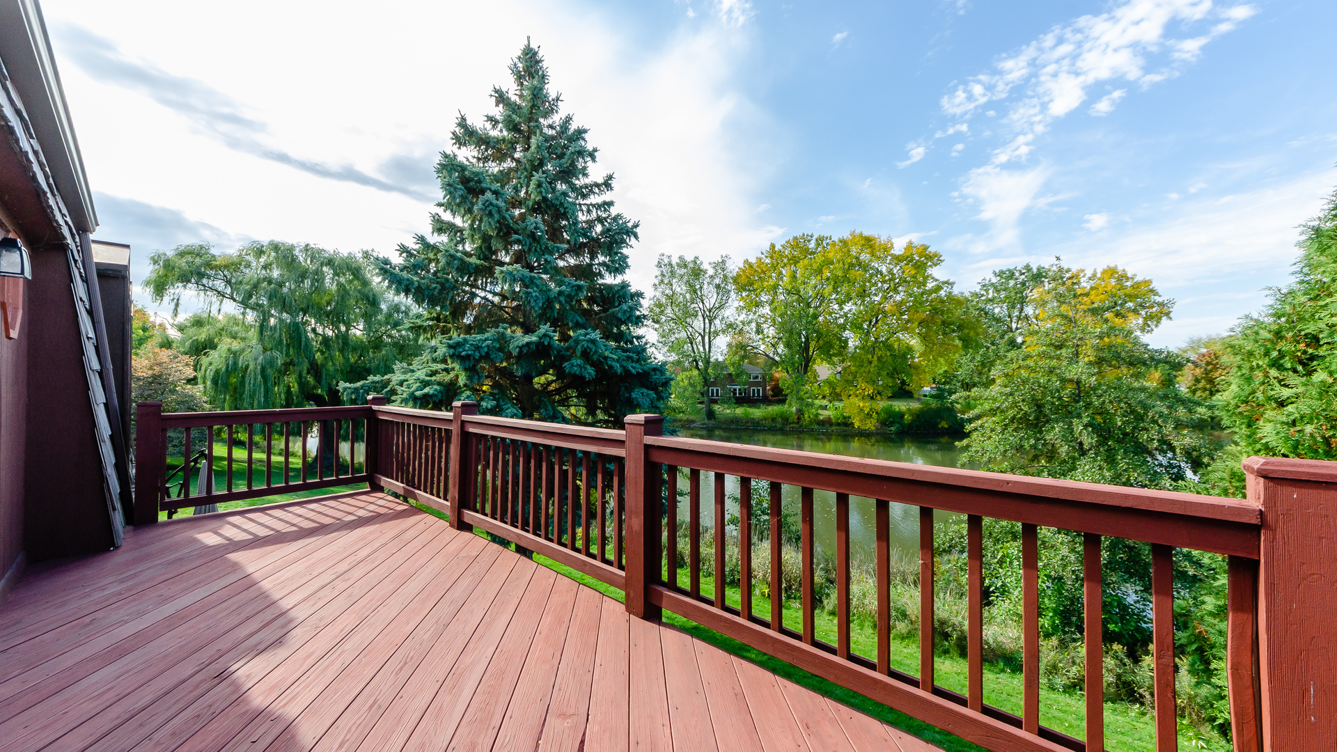 940 Gannon Drive Hoffman Estates, IL 60169 - Photo 16 of 20 a balcony with wooden floor and trees in the back
