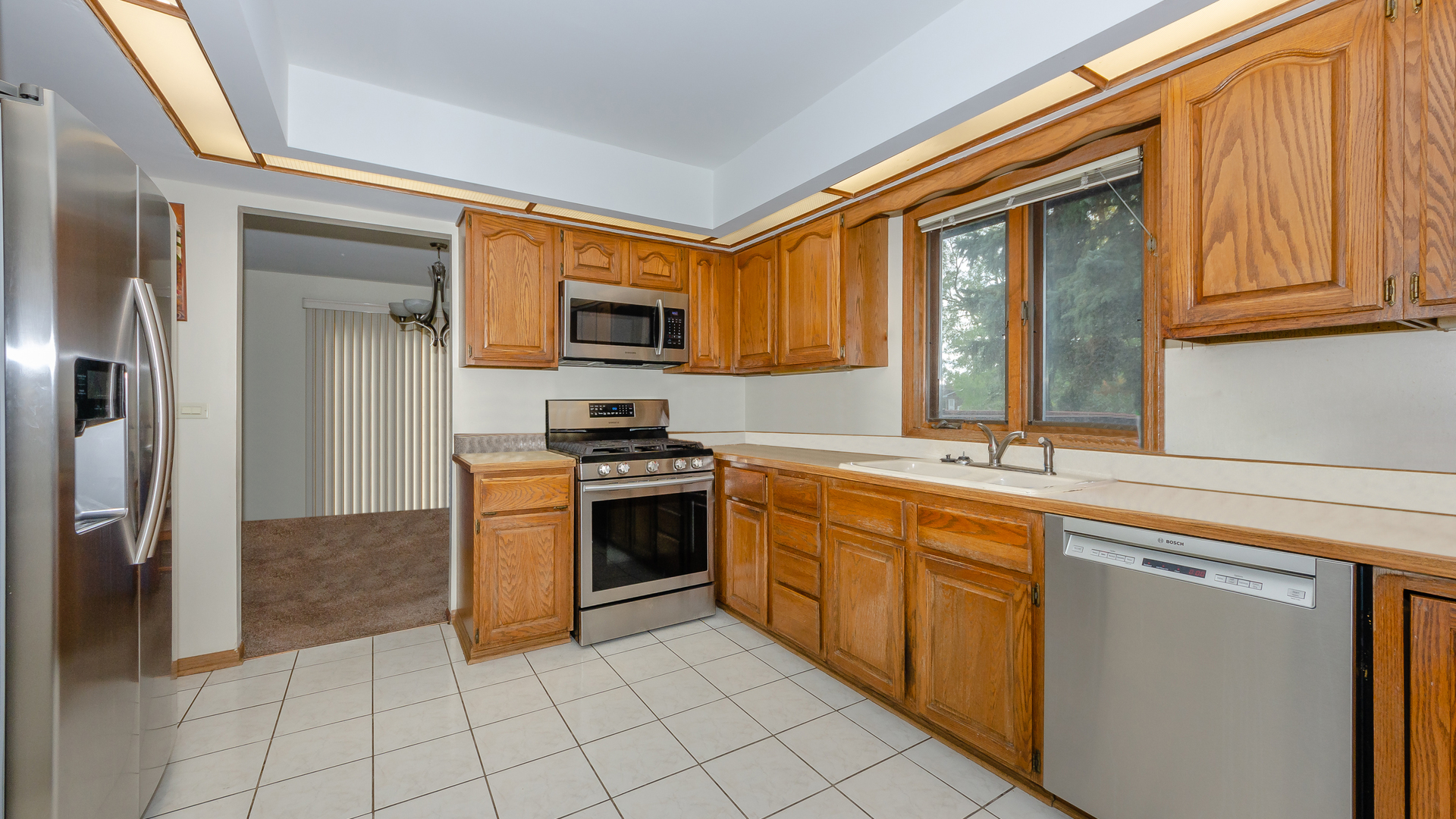 940 Gannon Drive Hoffman Estates, IL 60169 - Photo 6 of 20 a kitchen with stainless steel appliances granite countertop a stove top oven a sink and a refrigerator