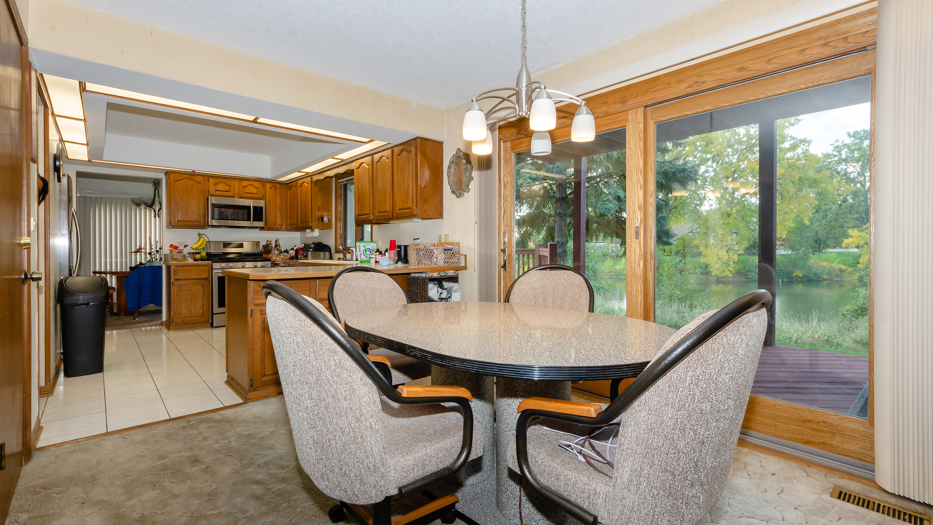 940 Gannon Drive Hoffman Estates, IL 60169 - Photo 7 of 20 a dining room with furniture a chandelier and fireplace